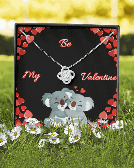 14k white gold love knot necklace in soft box with greeting card in grass