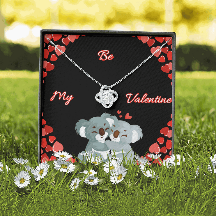 14k white gold love knot necklace in soft box with greeting card in grass