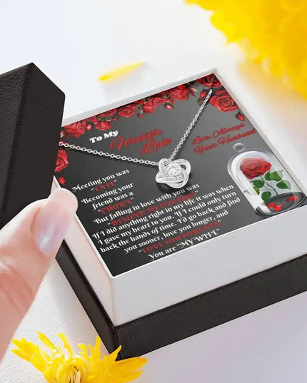 white gold love knot necklace in two-tone box angled left