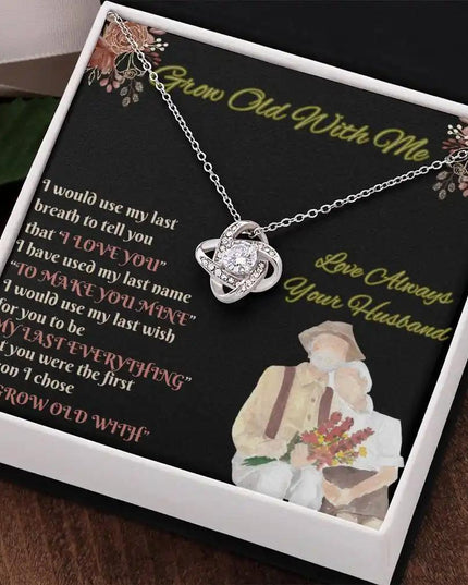 white gold love knot necklace in two-tone box angled right