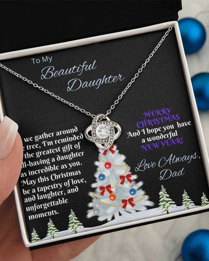 white gold love knot necklace in soft box in model's hand