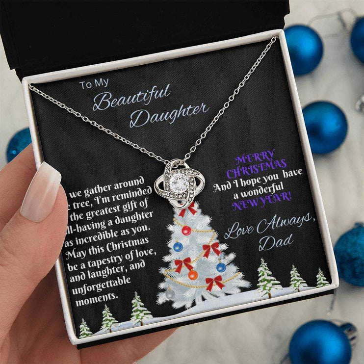 white gold love knot necklace in soft box in model's hand