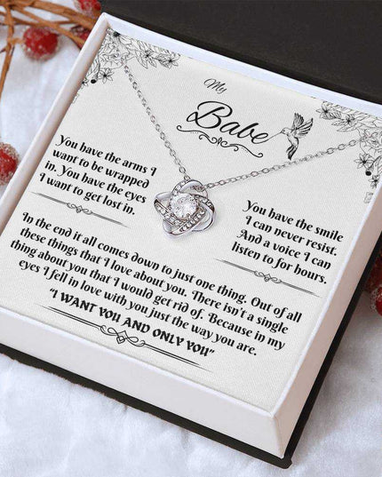 white gold love knot necklace in soft box angled right