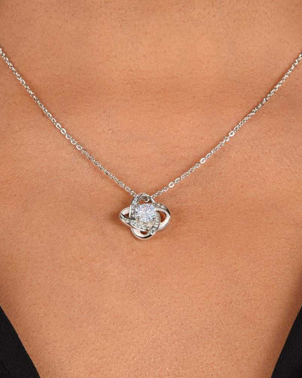 white gold love knot necklace on model's neck