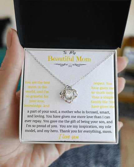 A white gold love knot necklace in a two-tone box