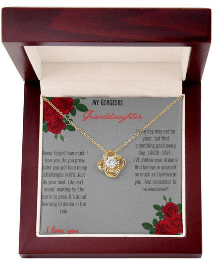 Love Knot Necklace with a yellow gold love knot in a mahogany box angle 1