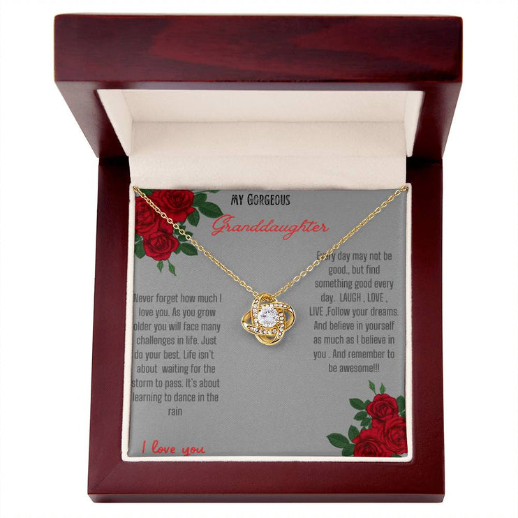 Love Knot Necklace with a yellow gold love knot in a mahogany box angle 1