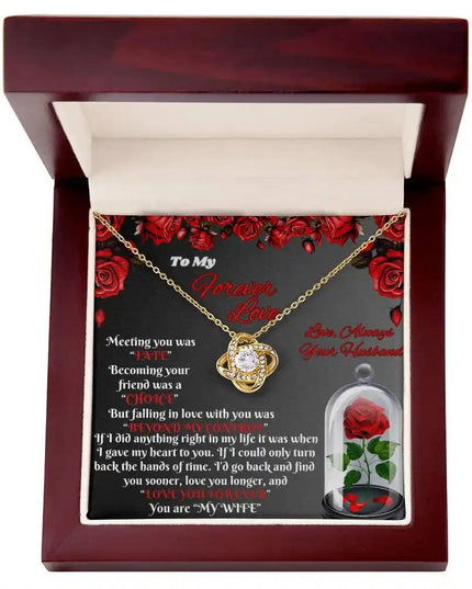 yellow gold love knot necklace in a mahogany box