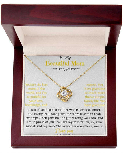 A yellow gold love knot necklace in a mahogany box