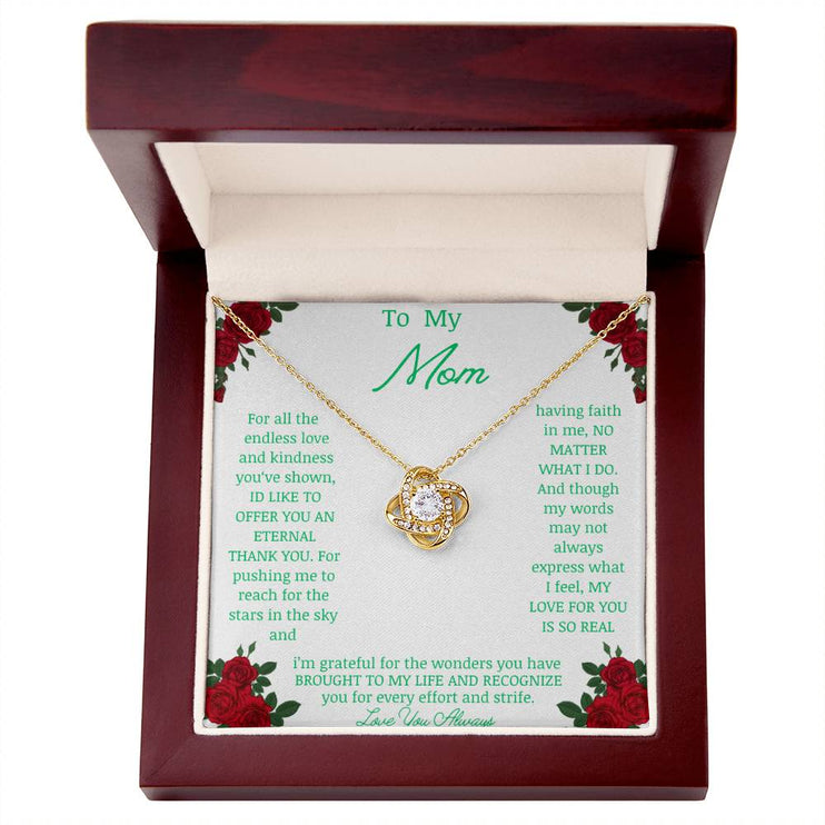 Love Knot Necklace with yellow gold pendant in a mahogany box angle 2