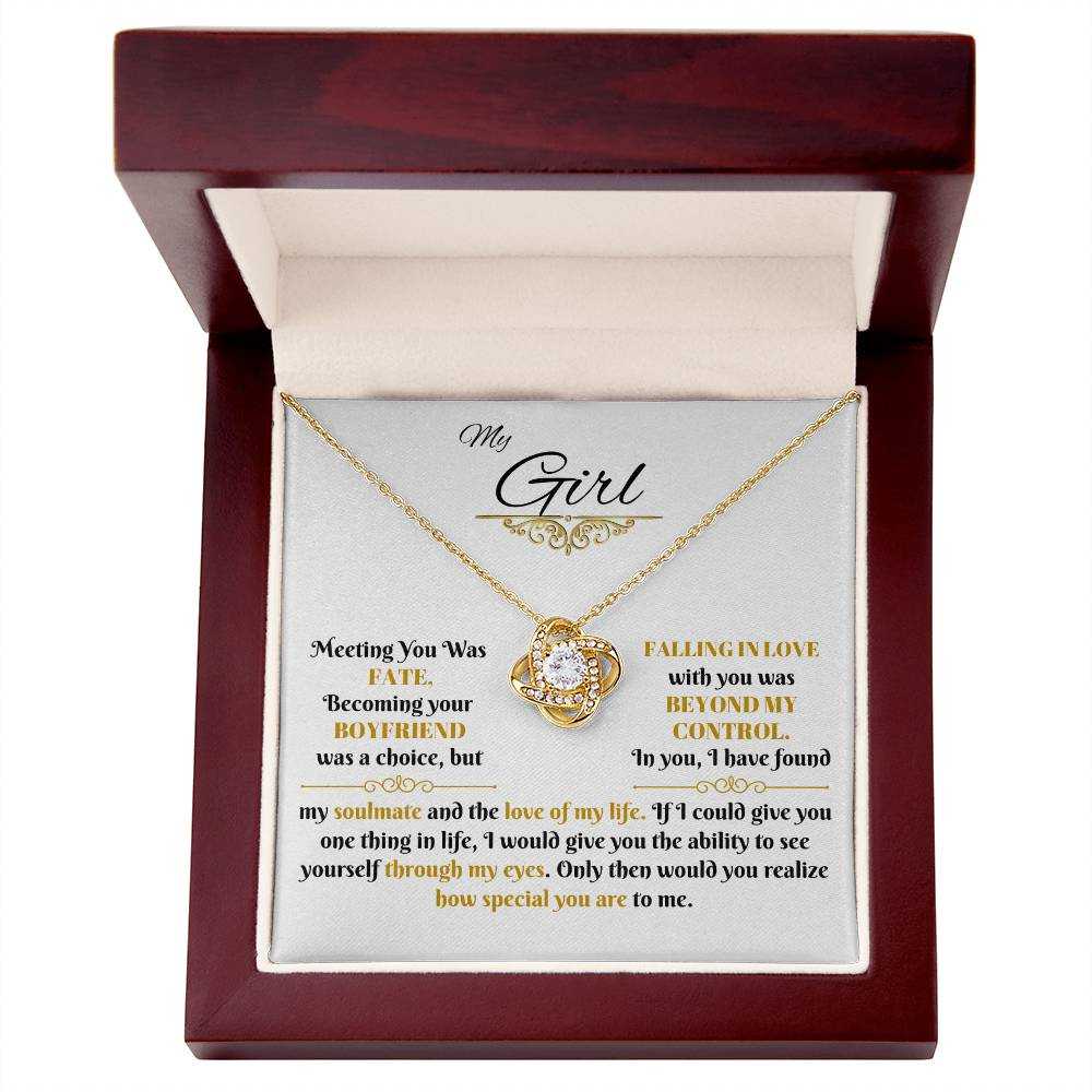 yellow gold love knot necklace in a luxury box up close