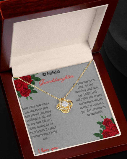 Love Knot Necklace with a yellow gold love knot in a mahogany box angle 2