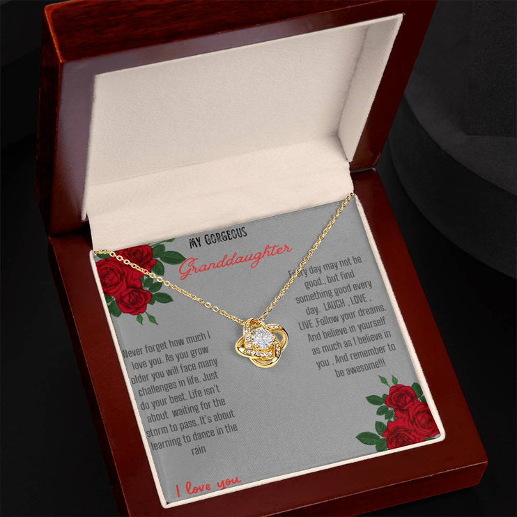 Love Knot Necklace with a yellow gold love knot in a mahogany box angle 2