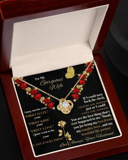yellow gold love knot necklace in mahogany box angled left