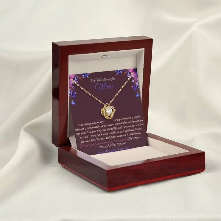 yellow gold love knot necklace in mahogany box angled left