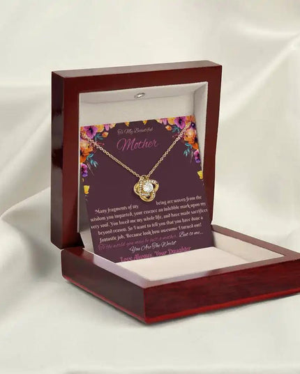 yellow gold love knot necklace in mahogany box angled left