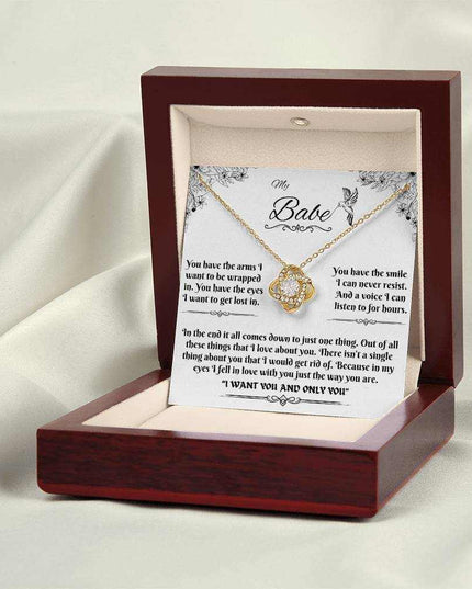 yellow gold love knot necklace in luxury box on a white cloth