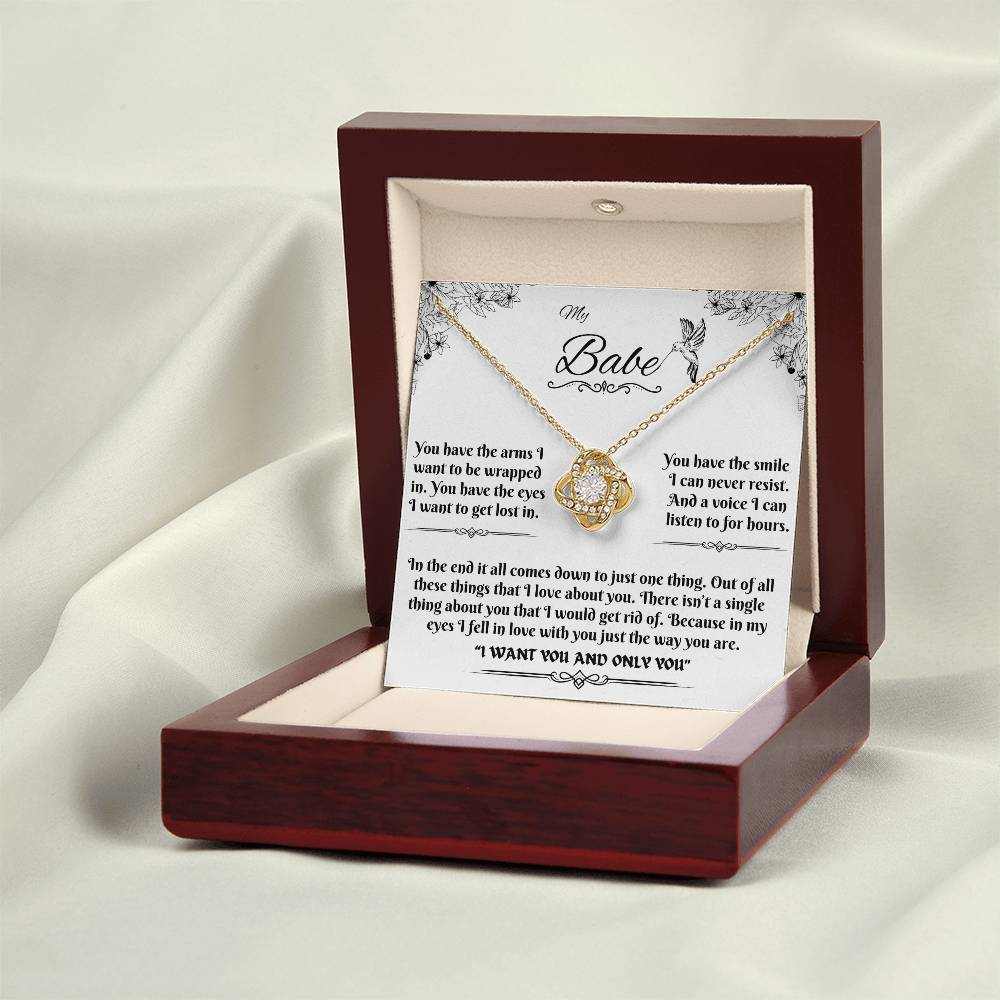 yellow gold love knot necklace in luxury box on a white cloth