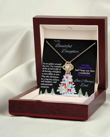 yellow gold love knot necklace in a luxury box on a white cloth backdrop