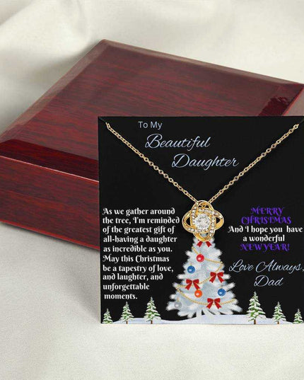 yellow gold love knot necklace outside of a luxury box 