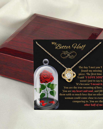 18k gold love knot necklace outside of closed luxury box on card