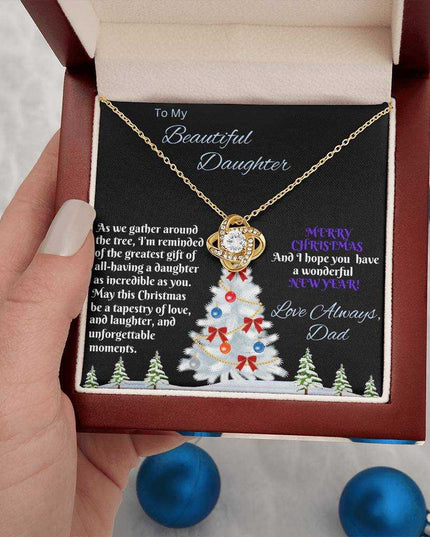 yellow gold love knot necklace in luxury box in a model's hand