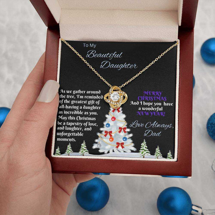 yellow gold love knot necklace in luxury box in a model's hand