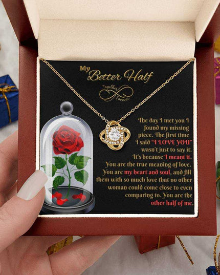 18k gold love knot necklace in luxury box in model's hands