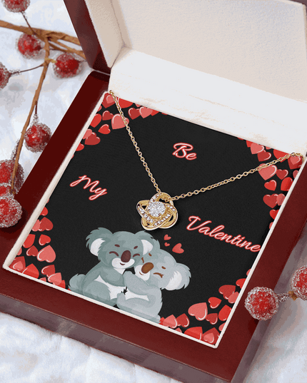 18k gold love knot necklace in a luxury box with red beads