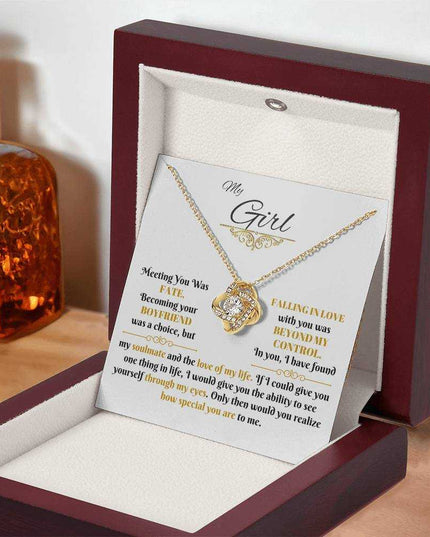 yellow gold love knot necklace in a luxury box angled right
