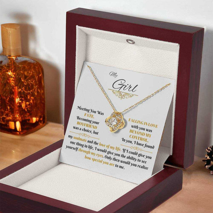 yellow gold love knot necklace in a luxury box angled right