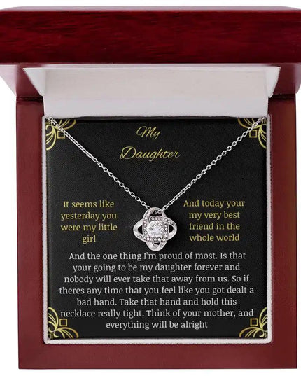 Love Knot Necklace with a white gold charm in a mahogany box with a to daughter from mom greeting card close up