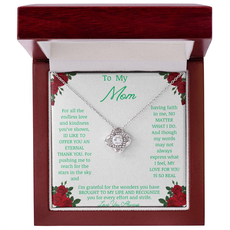 Love Knot Necklace with white gold pendant in a mahogany box angle 1