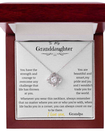 a white gold love knot necklace in a mahogany box