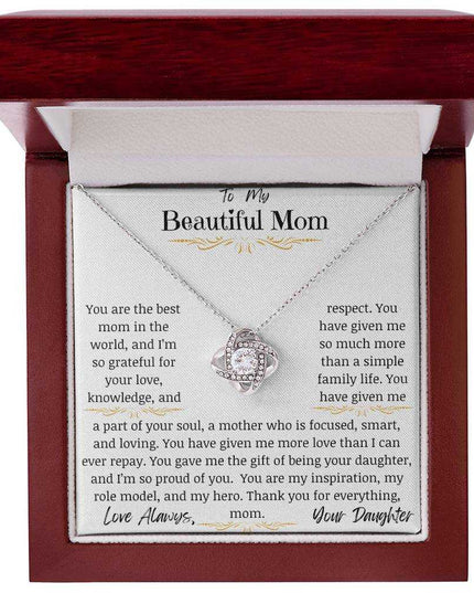 a white gold love knot necklace in a mahogany box