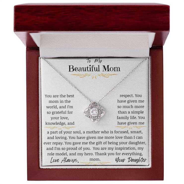 a white gold love knot necklace in a mahogany box
