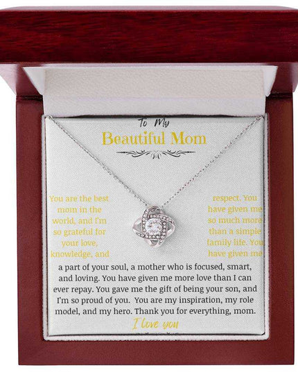 A white gold love knot necklace in a mahogany box