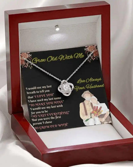 white gold love knot necklace in mahogany box on white cloth
