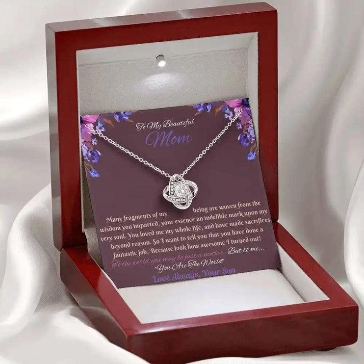 white gold love knot necklace in mahogany box angled left