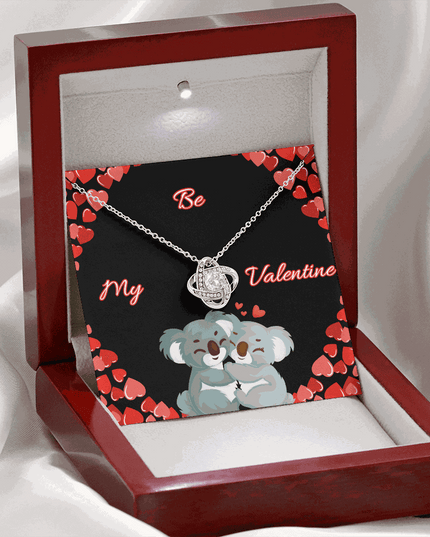 14k white gold love knot necklace in a mahogany box with LED on