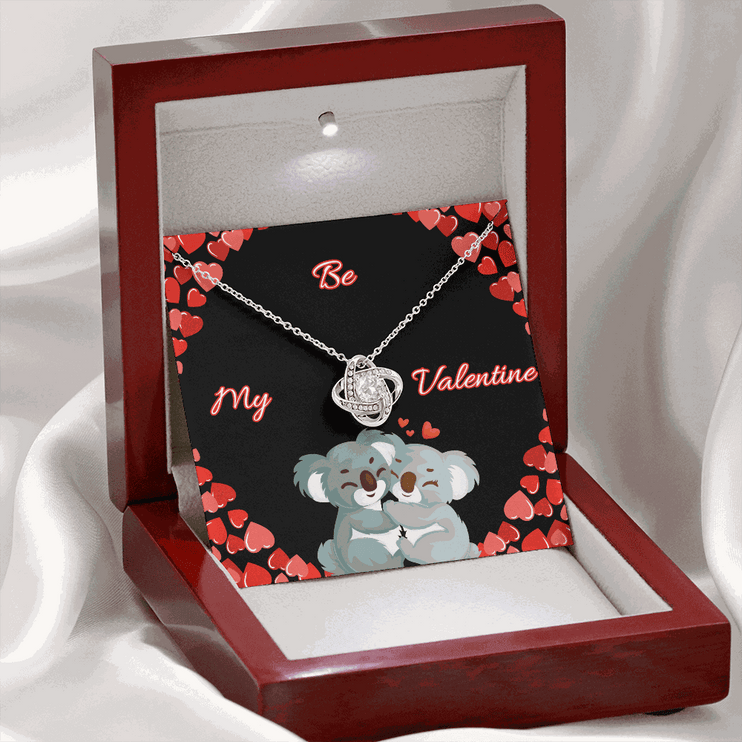 14k white gold love knot necklace in a mahogany box with LED on
