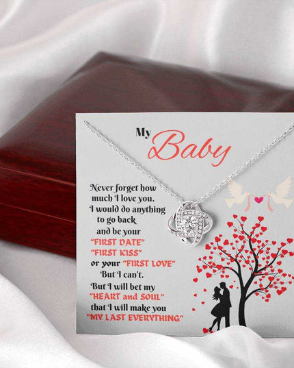 white gold love knot necklace outside of closed luxury box