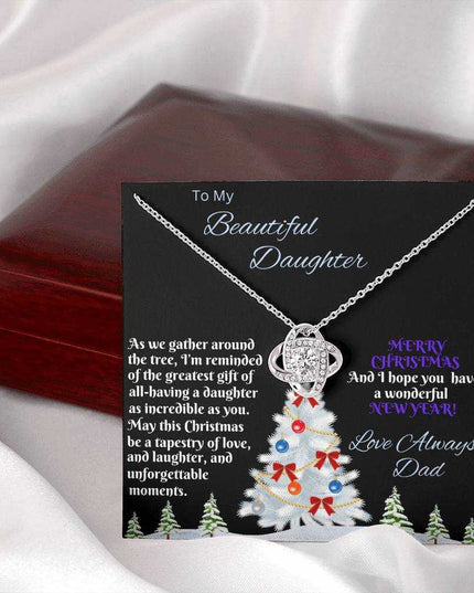 white gold love knot necklace outside of closed luxury box 