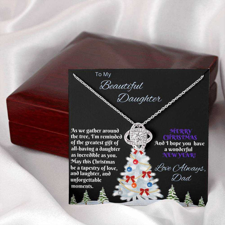 white gold love knot necklace outside of closed luxury box 