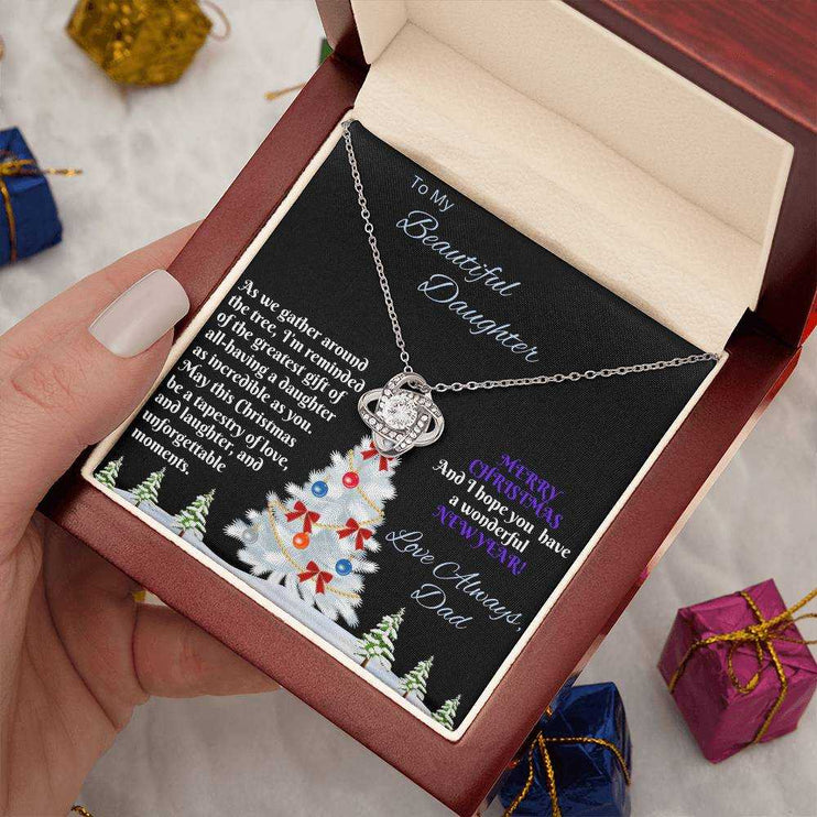 white gold love knot necklace in luxury box in model's hand