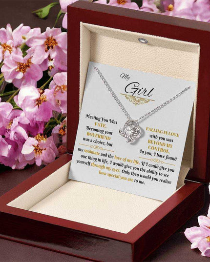 white gold love knot necklace in a luxury box angled right