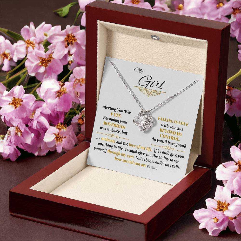 white gold love knot necklace in a luxury box angled right