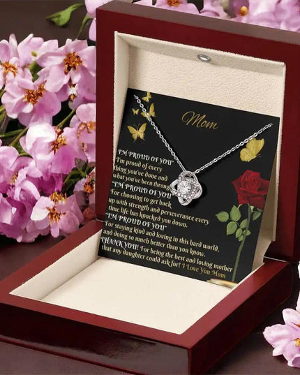 white gold love knot necklace in mahogany box angled right