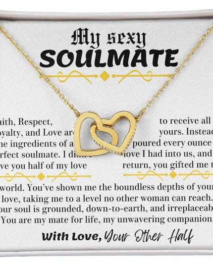 a yellow gold interlocking hearts necklace in a two-tone box up close