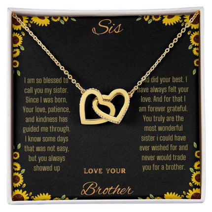 Interlocking Hearts Necklace with a gold variant on a To Sis from Brother greeting card up close